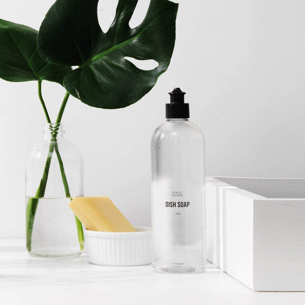 Bottle of dish soap on counter, bar soap, green plant in glass vase
