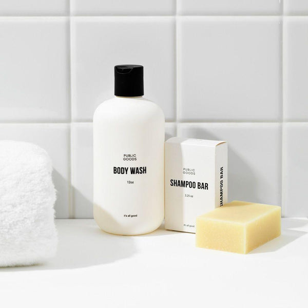 public goods body wash, public goods shampoo bar packaging, unwrapped shampoo bar, folded bath towel, bathroom counter