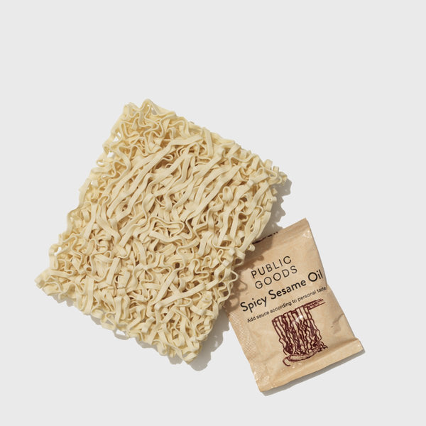 uncooked ramen noodles, spicy sesame oil sauce packet